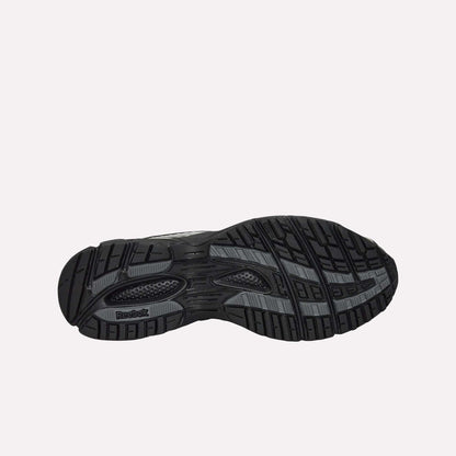 The image displays the black rubber sole of the Reebok Premier Road Ultra Shoes, featuring a textured tread for grip and the Reebok logo by the heel. The background is plain white.