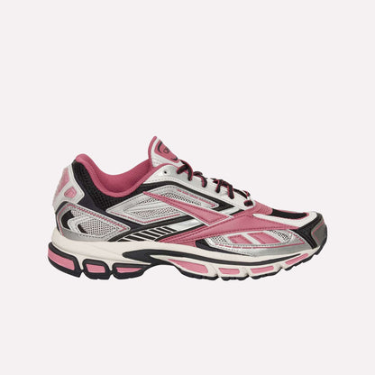 The Reebok Premier Road Ultra Shoes feature a pink, white, and black design with mesh and synthetic overlays, a lace-up closure, and a cushioned dual-density midsole for comfort.