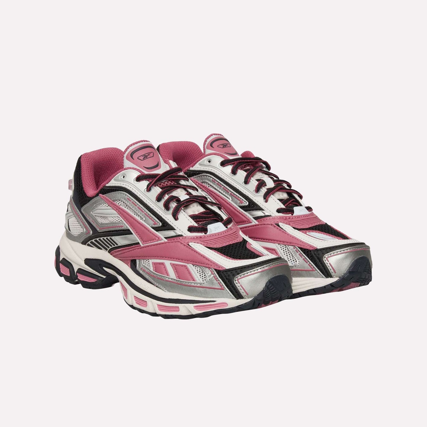 The Reebok Premier Road Ultra Shoes are athletic sneakers in pink, silver, black, and white, featuring mesh and synthetic panels, lace-up fronts, a dual-density midsole, and thick textured soles inspired by classic running style.