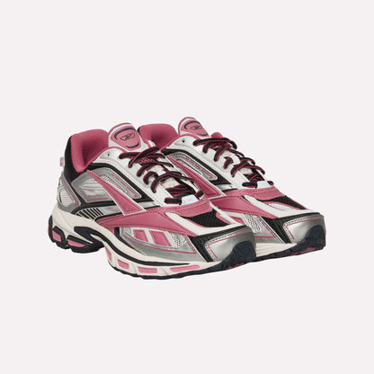 The Reebok Premier Road Ultra Shoes are athletic sneakers in pink, silver, black, and white, featuring mesh and synthetic panels, lace-up fronts, a dual-density midsole, and thick textured soles inspired by classic running style.