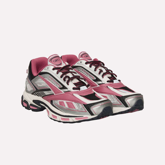 The Reebok Premier Road Ultra Shoes are athletic sneakers in pink, silver, black, and white, featuring mesh and synthetic panels, lace-up fronts, a dual-density midsole, and thick textured soles inspired by classic running style.