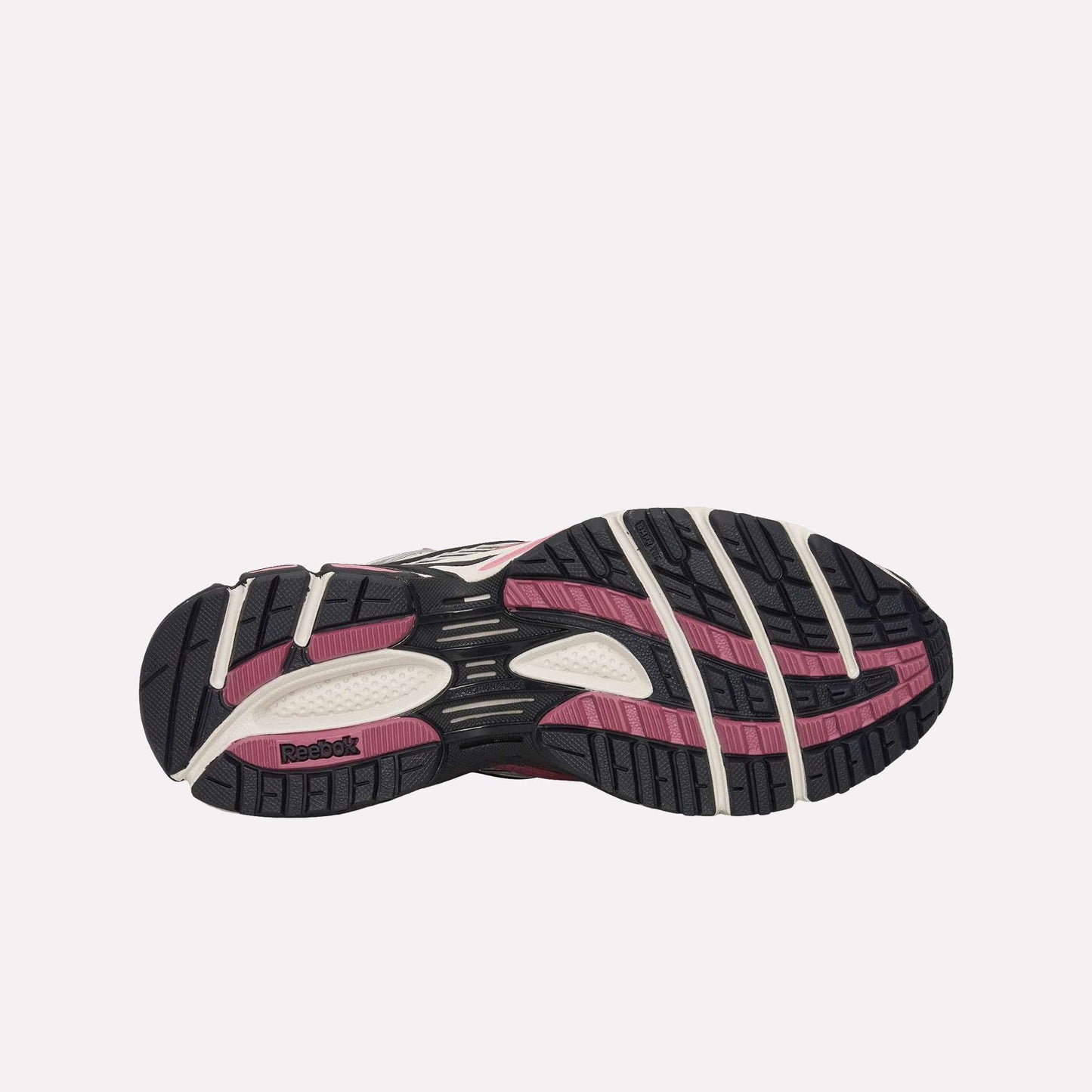 Bottom view of the Reebok Premier Road Ultra Shoes, featuring a textured black, pink, and white rubber outsole with grooves and a Reebok logo by the heel—engineered for comfort with a dual-density midsole.