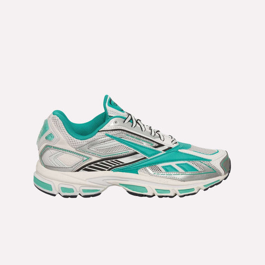 The Reebok Premier Road Ultra Shoes, shown in profile against a light blue background, feature white mesh uppers with teal and black accents and a thick dual-density midsole for an archival running silhouette.