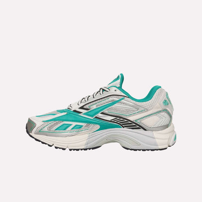 The Reebok Premier Road Ultra Shoes are white athletic sneakers with teal and black accents, shown from the side on a light blue background. Inspired by archival running styles, they feature mesh panels and a dual-density midsole for comfort.
