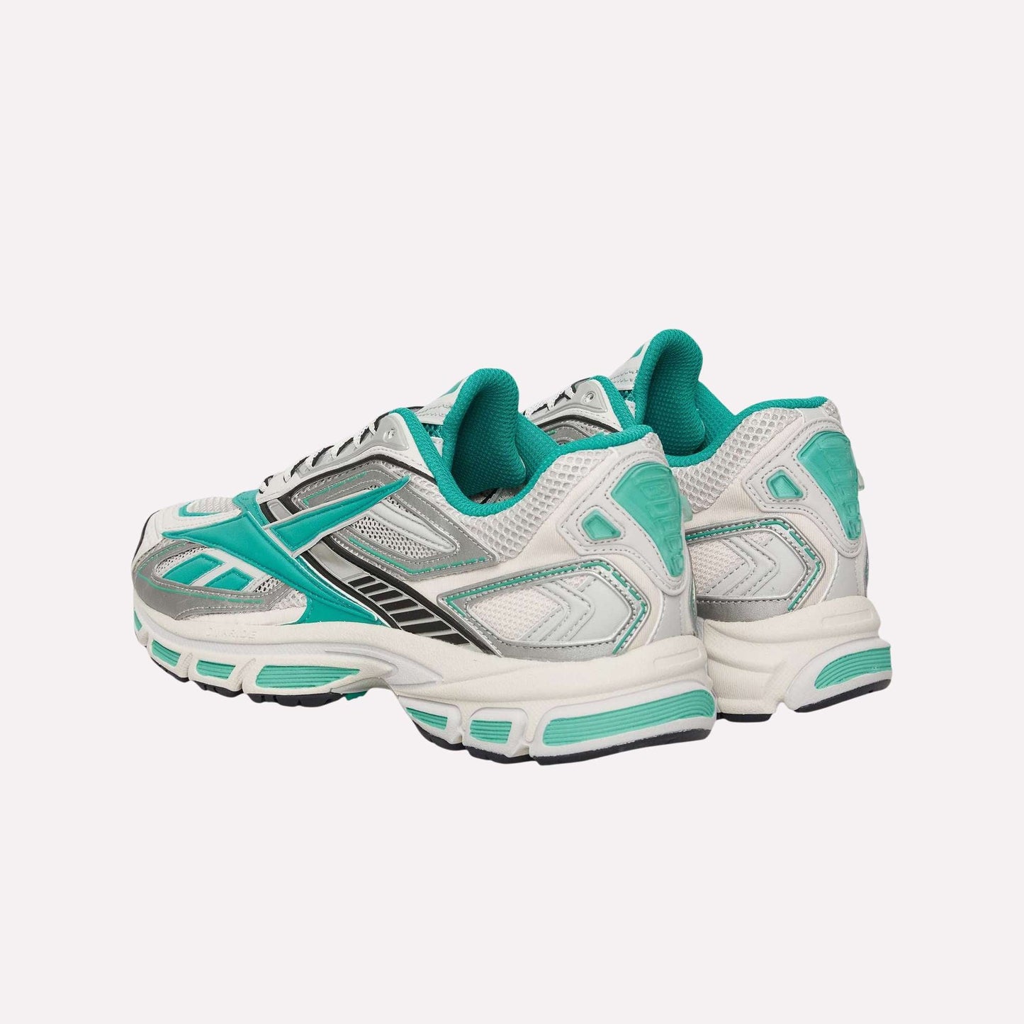 The Reebok Premier Road Ultra Shoes feature white uppers with teal and silver accents, black details, a dual-density midsole, and teal inner lining, shown on a light blue background.