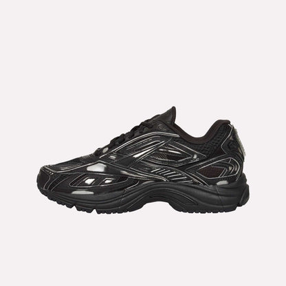 The Reebok Premier Road Ultra Shoes feature a black, glossy finish with geometric side patterns and a dual-density midsole for comfort—displayed in profile against a white background.