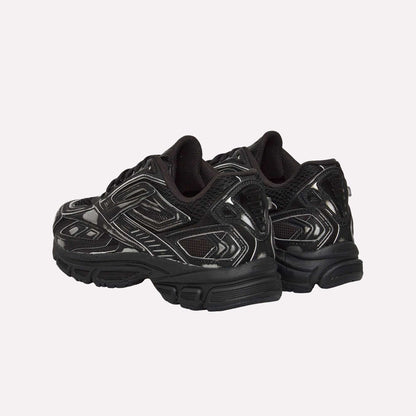 The Reebok Premier Road Ultra Shoes in black with silver accents are shown from the back and slightly to the side, featuring thick soles, breathable mesh panels, and a supportive dual-density midsole.