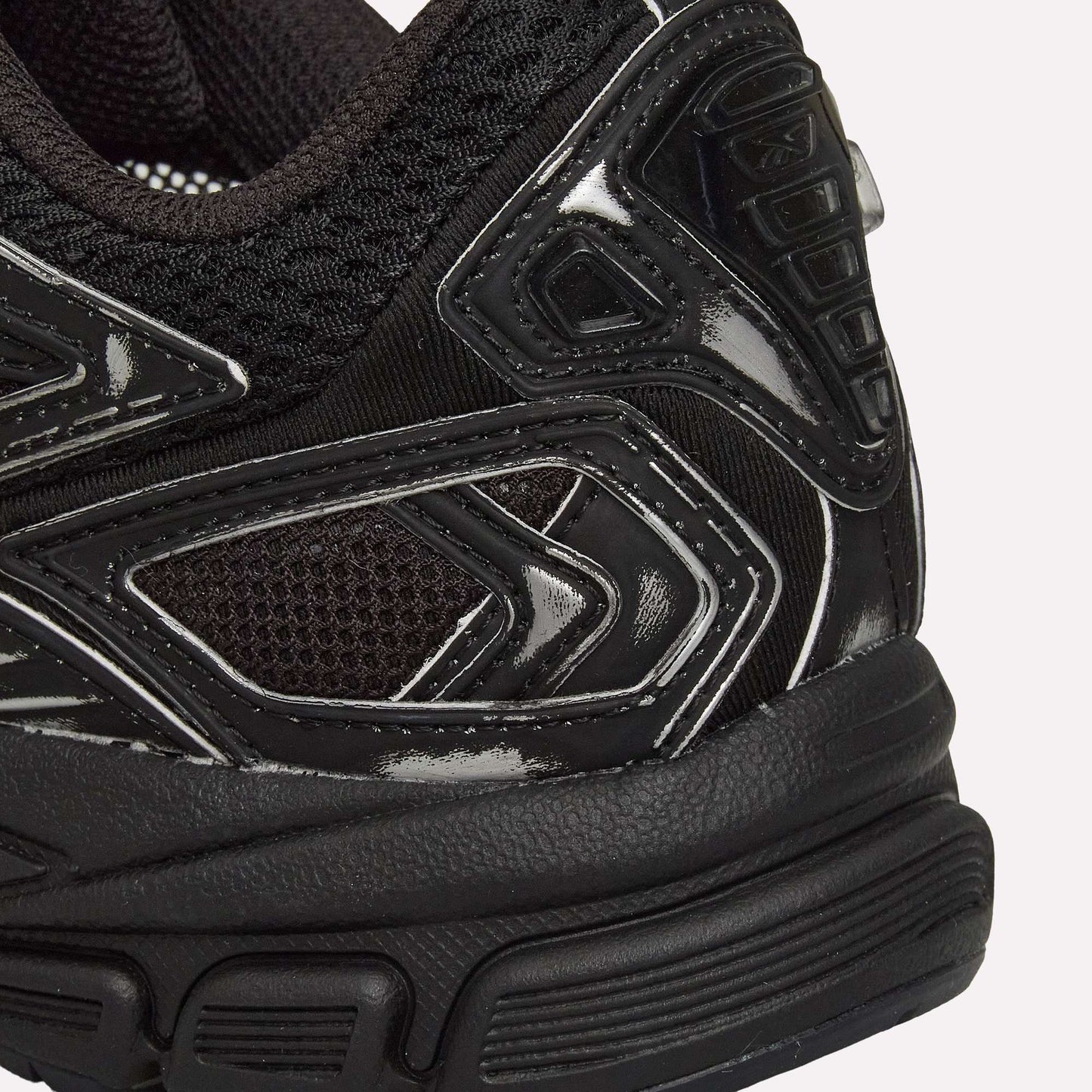 Close-up of the heel and side of Reebok Premier Road Ultra Shoes, highlighting textured mesh, glossy synthetic overlays, detailed stitching, and the dual-density midsole.
