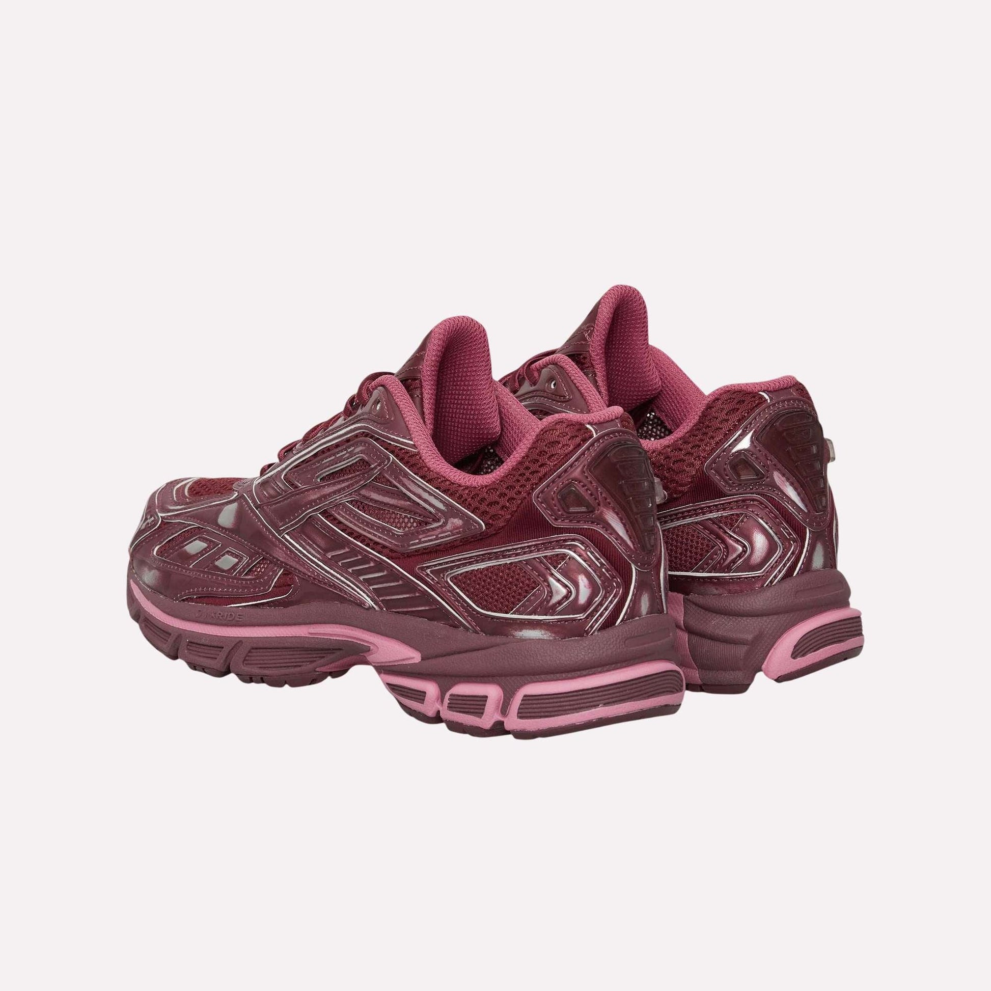The Reebok Premier Road Ultra Shoes in maroon feature glossy details and pink accents, designed for comfort and stability, displayed from the back and side on a white background.