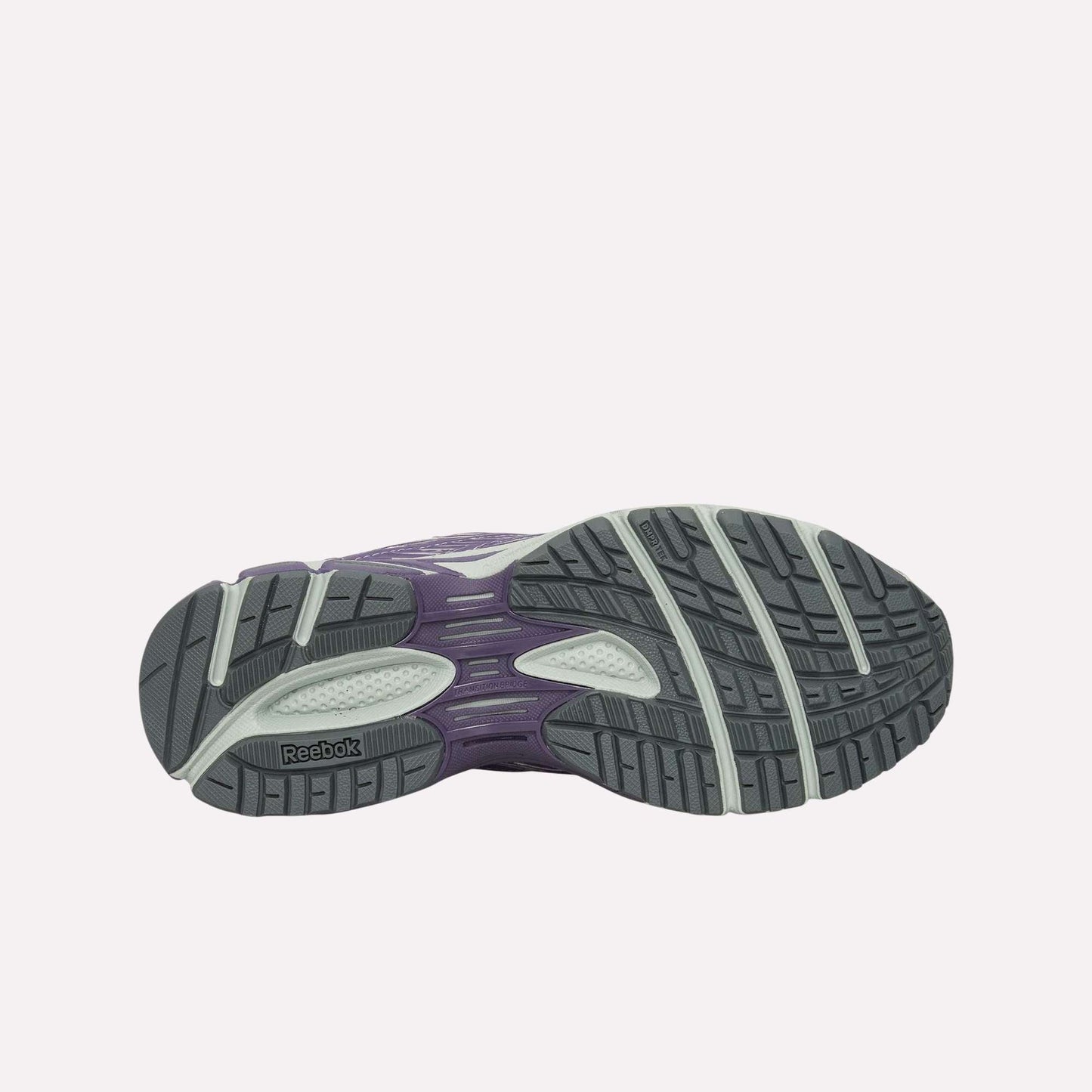 The image displays the outsole of the Reebok Premier Road Ultra Shoes, featuring a tread with dark gray, light gray, and purple sections for traction and support, as well as a dual-density midsole.