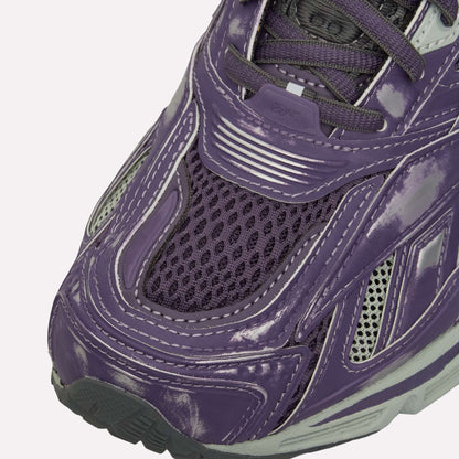 Close-up of the Reebok Premier Road Ultra Shoes, showing shiny distressed purple leather, silver accents, mesh at the toe, dark purple laces, layered textures, and a modern dual-density midsole design.