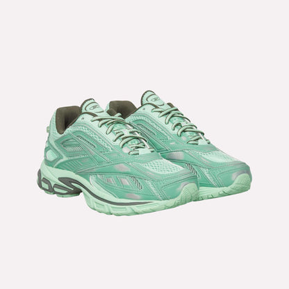 A pair of Reebok Premier Road Ultra Shoes in light mint green with mesh and synthetic overlays, gray accents, lace-up closures, and cushioned dual-density midsoles are displayed on a white background.