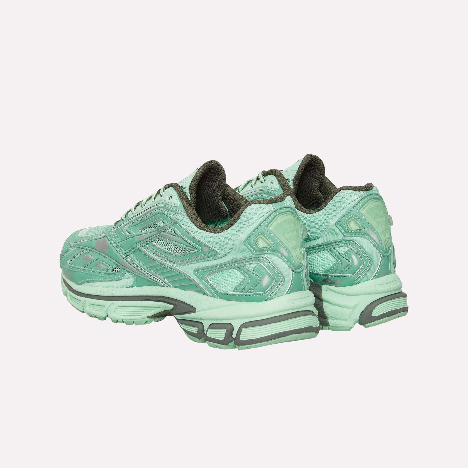A pair of Reebok Premier Road Ultra Shoes in mint green with dark green accents and thick, textured soles with a dual-density midsole, shown from an angled rear view.