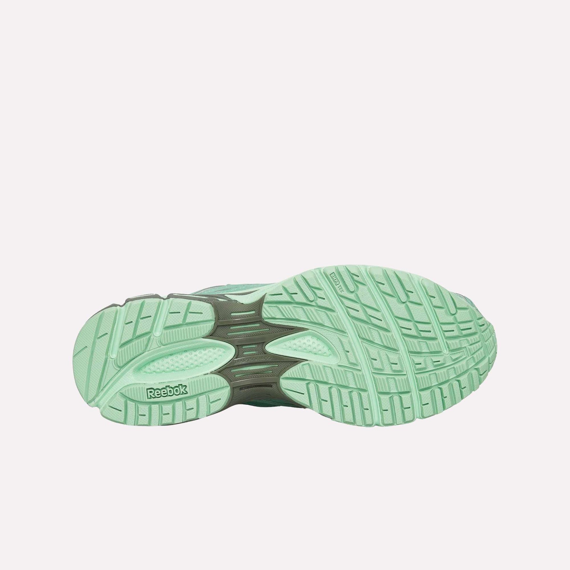 The image displays the sole of the Reebok Premier Road Ultra Shoes in mint green, highlighting textured grip patterns, a black arch support section, and visible details of its dual-density midsole for enhanced comfort.