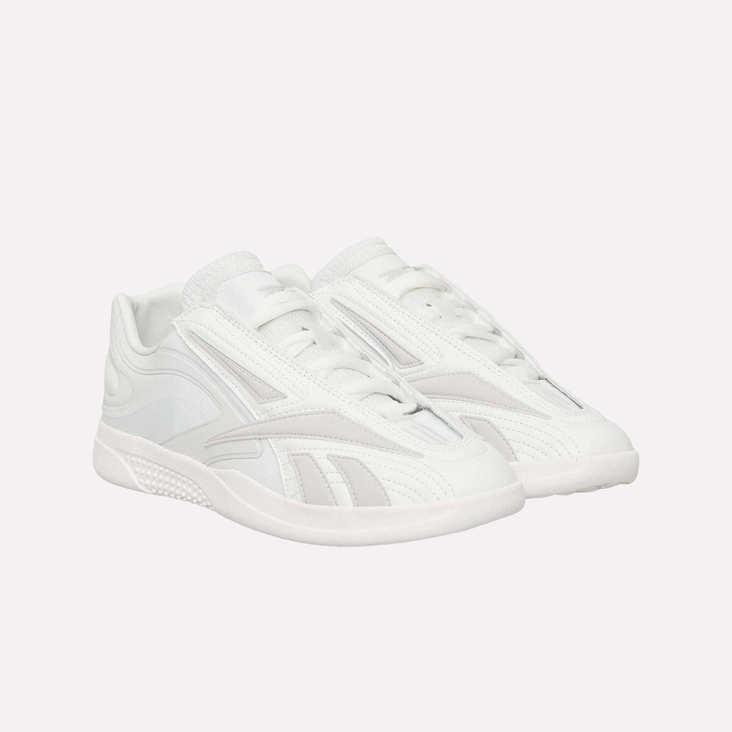 A pair of Reebok Hammer Pro LTD Shoes in white faux leather with a sleek low-top design, subtle textured patterns, and durable rubber soles, displayed side by side on a white background.
