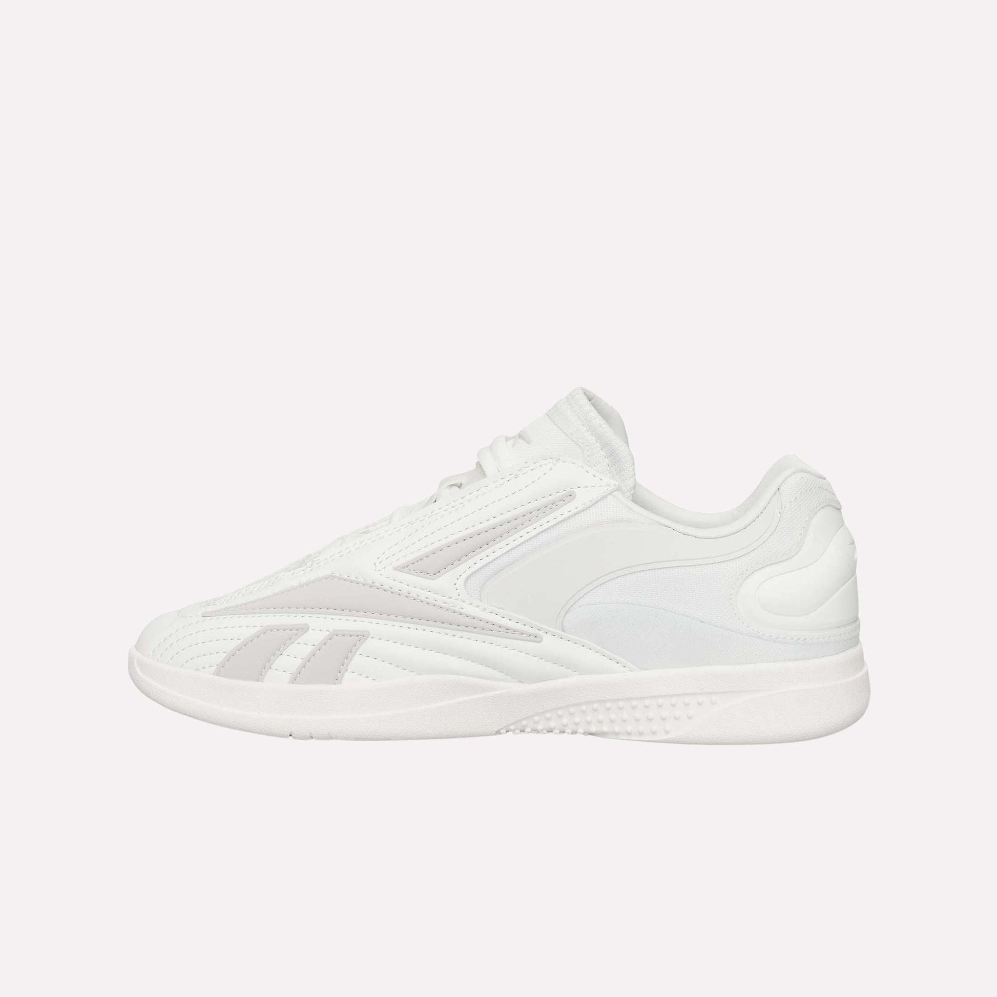 A white Reebok Hammer Pro LTD Shoe with light gray accents, a durable rubber sole, lace-up closure, and smooth faux leather panels, shown from the side on a plain white background.