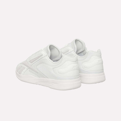 The Reebok Hammer Pro LTD Shoes are shown from the back and side, boasting a sleek minimal design, durable textured rubber soles, and subtle stitching details.