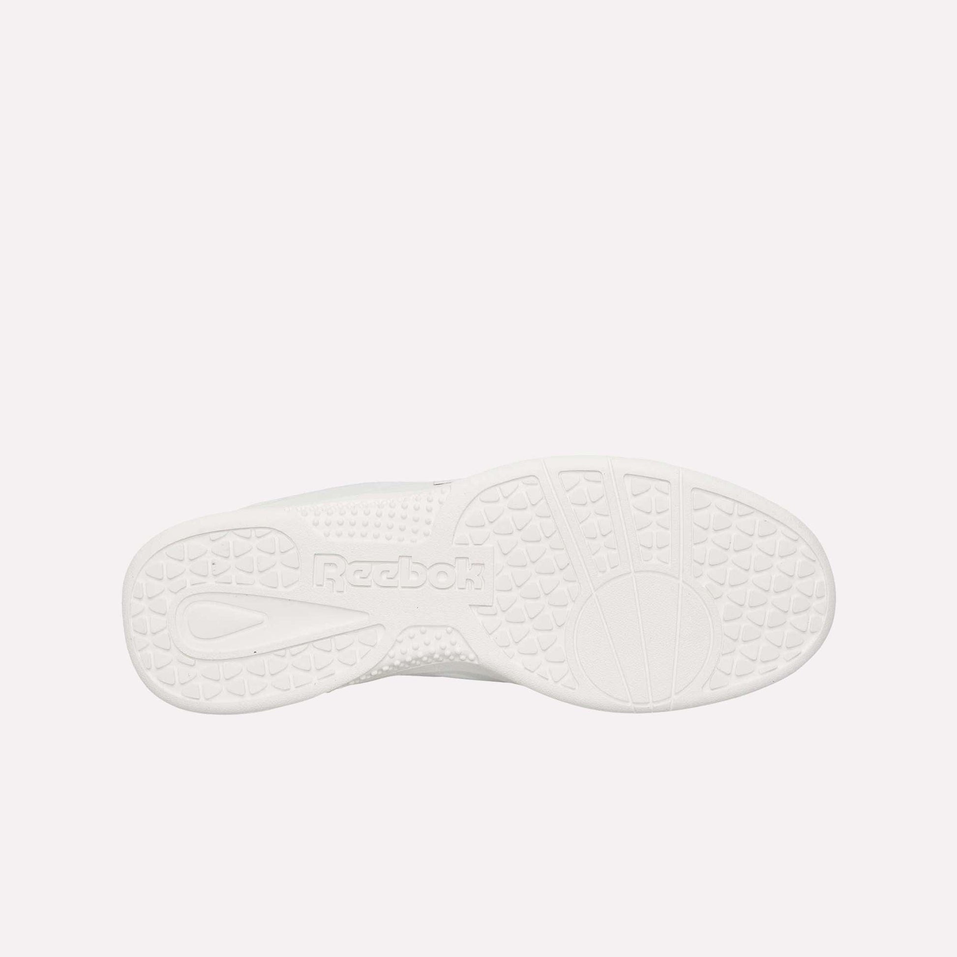 The image displays the bottom of a white Reebok Hammer Pro LTD Shoes sole, highlighting its textured grip patterns, durable rubber construction, and an embossed Reebok logo near the center.