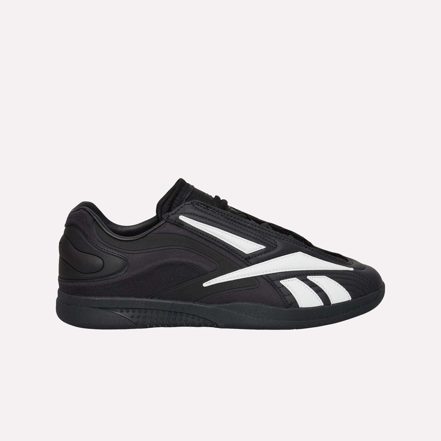 The Reebok Hammer Pro LTD Shoes, black faux leather low-tops with white stripes and a durable rubber sole, are shown in side profile against a plain white background.
