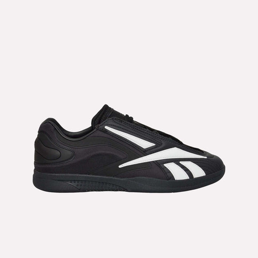 The Reebok Hammer Pro LTD Shoes, black faux leather low-tops with white stripes and a durable rubber sole, are shown in side profile against a plain white background.