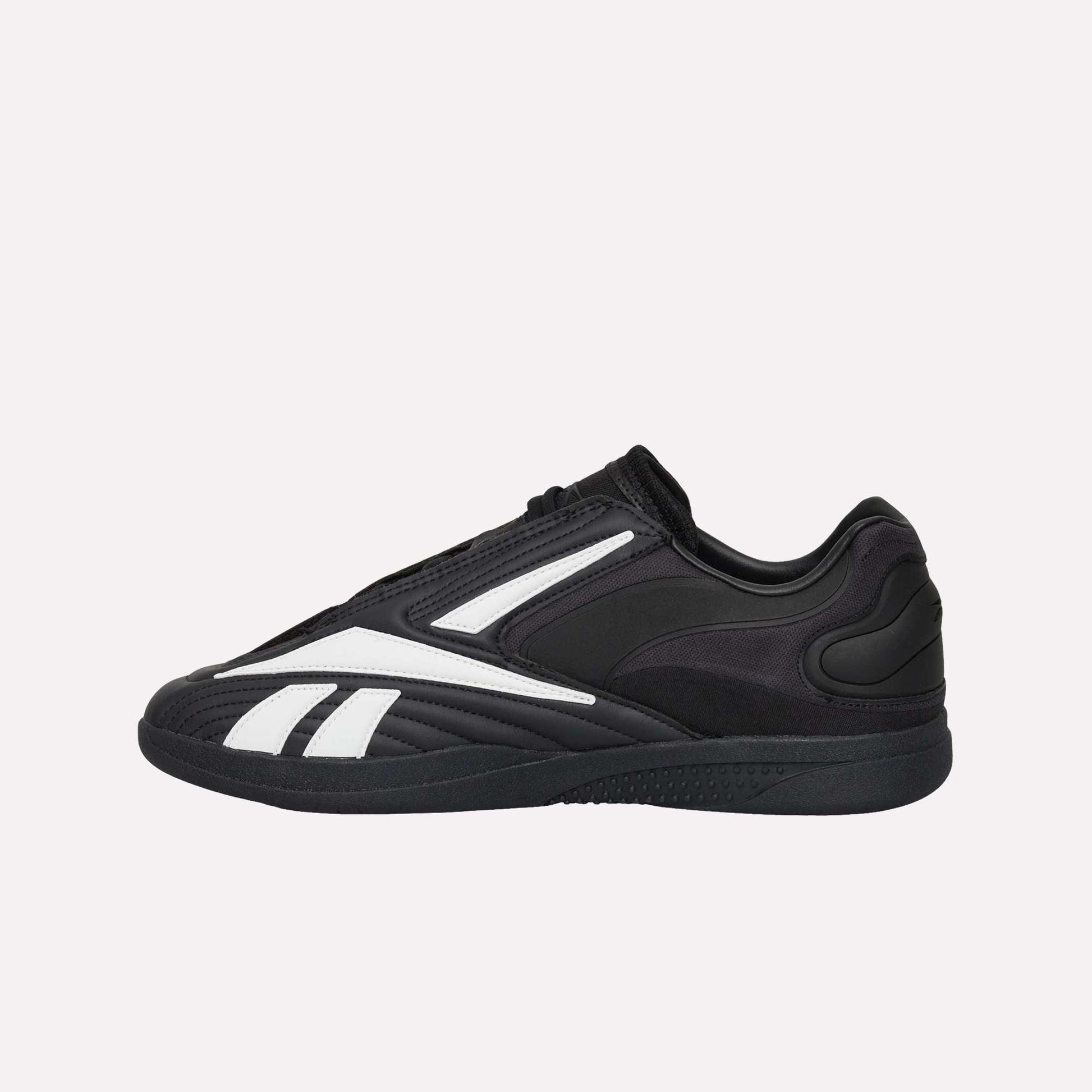 Reebok Hammer Pro LTD Shoes are black low-profile athletic sneakers with white geometric accents, a durable rubber sole, minimal branding, and precise stitching for a sleek, modern look.