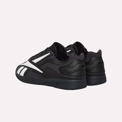 The Reebok Hammer Pro LTD Shoes feature a durable rubber sole, black faux leather upper, white accents, and the Reebok logo, shown from a rear side angle on a plain white background.