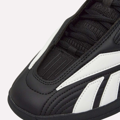 Close-up of Reebok Hammer Pro LTD Shoes in black with white accents, highlighting detailed stitching, laces, textured faux leather upper, and a durable rubber sole.