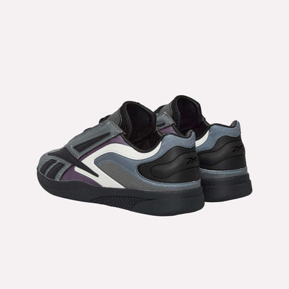 Reebok Hammer Pro LTD Shoes in grey, black, purple, and white faux leather feature layered panels. Styled heels forward to highlight the back and side details.