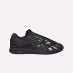A black Reebok Hammer Pro LTD Shoe with a glossy, textured faux leather upper, mesh and synthetic overlays, and a durable rubber sole, shown in side profile on a white background.