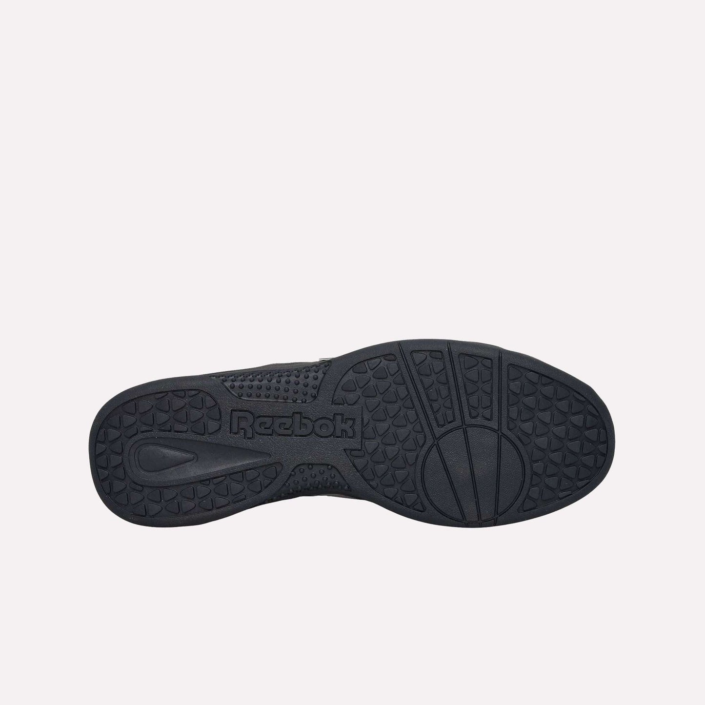 The image displays the black, durable rubber sole of the Reebok Hammer Pro LTD Shoes, showcasing textured grip patterns and a molded Reebok logo in the center.