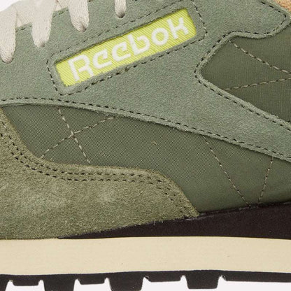 Close-up of the Reebok Classic Leather Premium LTD Shoes in green, highlighting suede and fabric textures, beige midsole, and a yellow patch with white Reebok logo—ideal for retro sneaker enthusiasts and lovers of classic silhouettes.