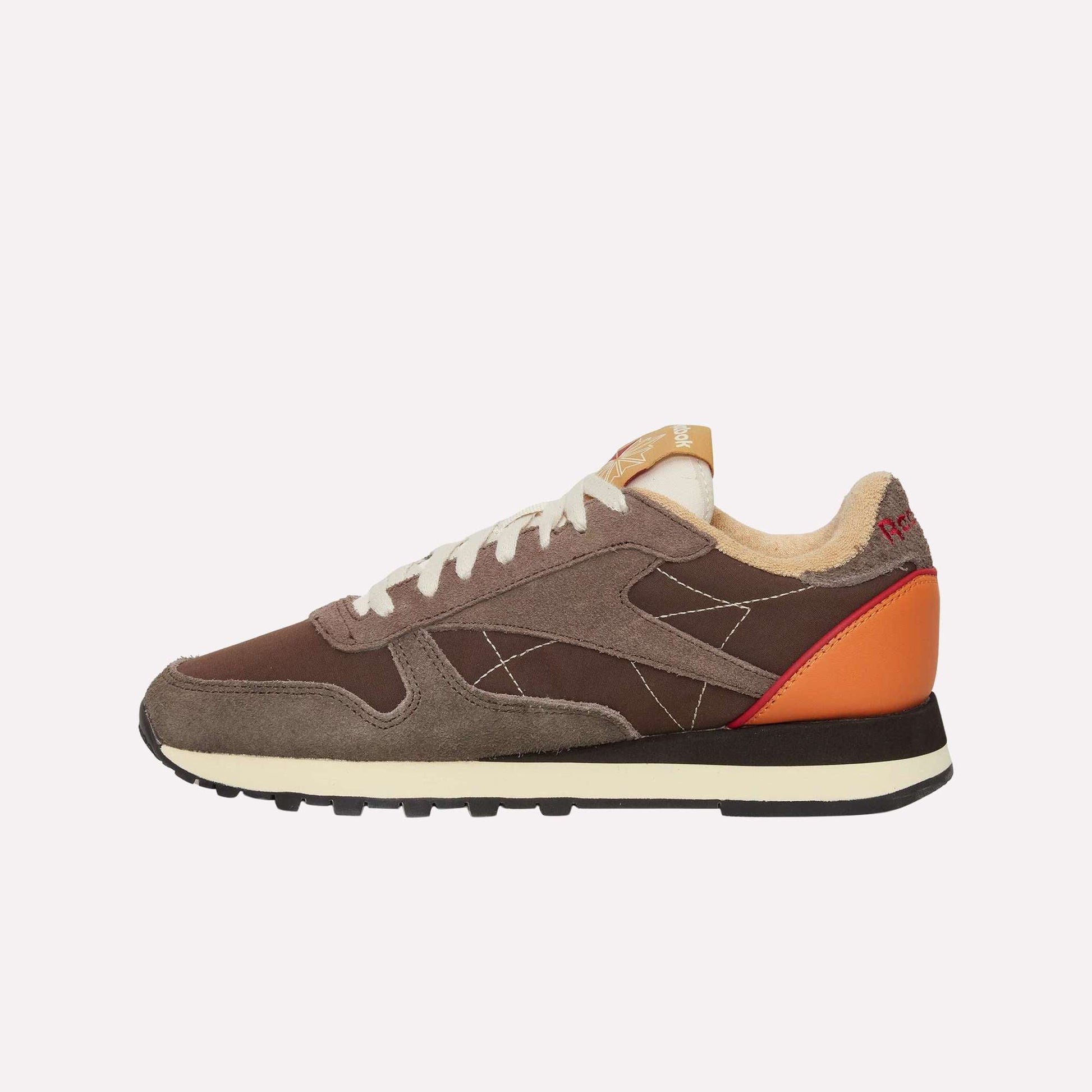 The Reebok Classic Leather Premium LTD Shoes feature brown and tan suede and fabric panels, white laces, a cream sole, orange heel detail, and red "HOFF" text on the heel. Shown from the side on a plain white background.
