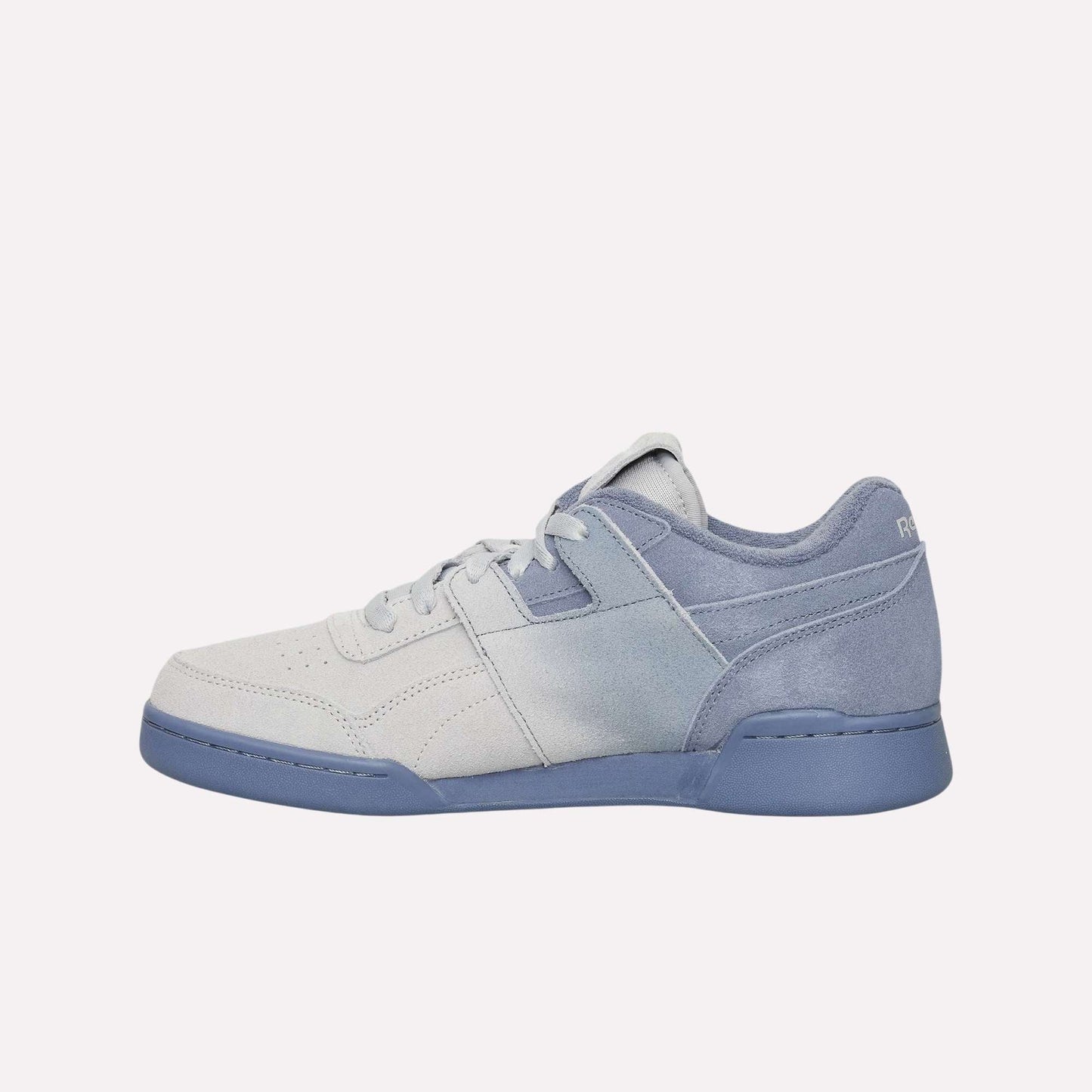 The Reebok Workout Plus OG Shoes feature a light blue and white gradient design with a blue sole, subtle heel branding, and classic silhouette, showcased on a light blue background.