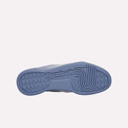 Against a light blue background, the textured sole of the Reebok Workout Plus Og Shoes is displayed, featuring the Reebok logo and reflecting the classic retro silhouette of these sneakers.