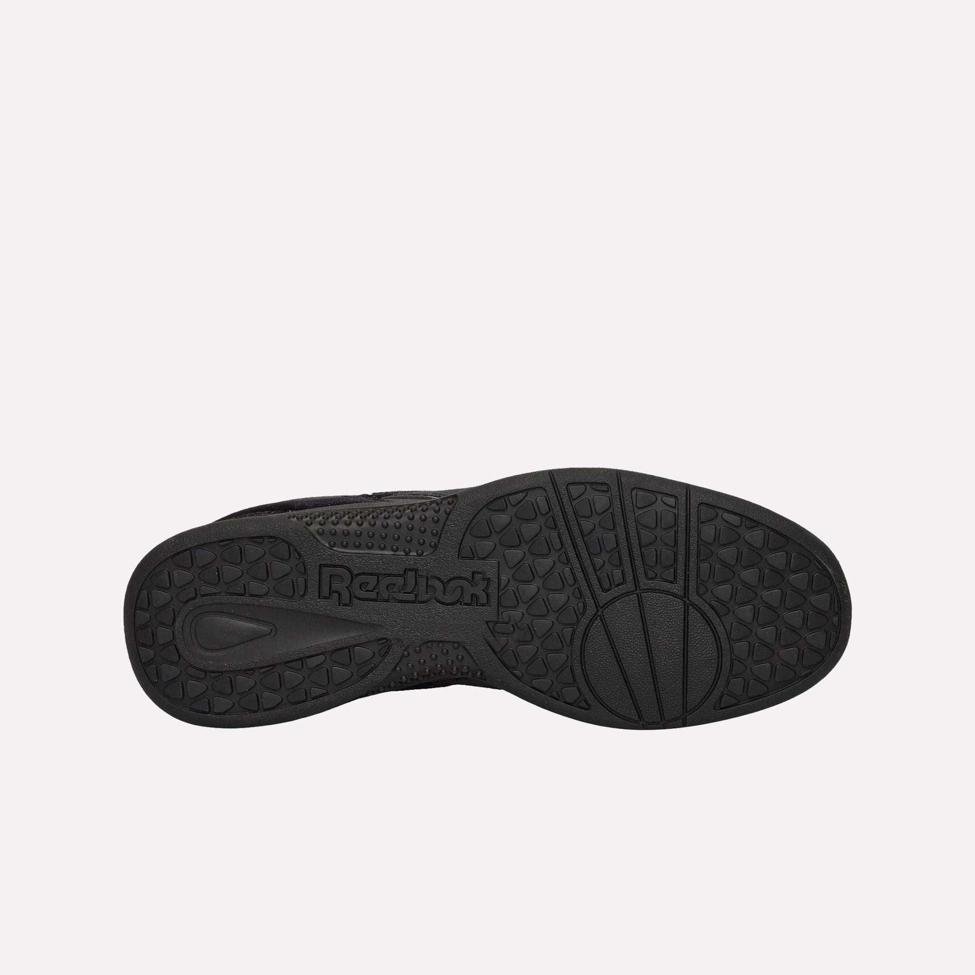 Black rubber sole of Reebok Pleasures Hammer Street Shoes displayed on a light blue background, featuring textured grip patterns, the Reebok logo, and geometric shapes for traction from the PLEASURES collaboration.
