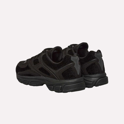 A pair of Reebok Pleasures Premier Trinity KFS Shoes with textured suede, mesh, and pony hair uppers, shown from the back and side against a plain light blue background.