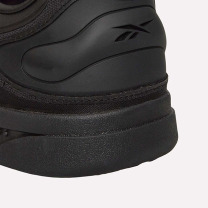 Close-up of the heel on a Reebok Hammer Pro Ltd sneaker, showing the embossed Reebok logo on the side. The shoe features a smooth upper and durable rubber sole.