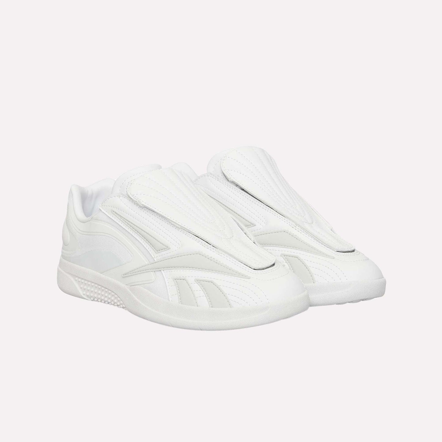 A pair of Reebok Hammer Pro Ltd sneakers, all white with a modern suede upper, closed tongue, and durable rubber sole, are pictured side by side against a white background.