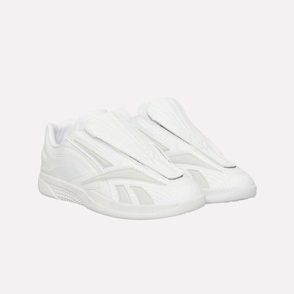 A pair of Reebok Hammer Pro Ltd sneakers, all white with a modern suede upper, closed tongue, and durable rubber sole, are pictured side by side against a white background.