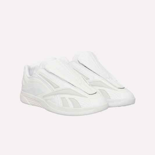 A pair of Reebok Hammer Pro Ltd sneakers, all white with a modern suede upper, closed tongue, and durable rubber sole, are pictured side by side against a white background.