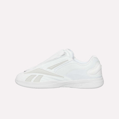 The Reebok Hammer Pro Ltd is a white low-top sneaker with a minimalist design, subtle stitching, durable rubber sole, and sleek lace-free suede upper for a modern look.