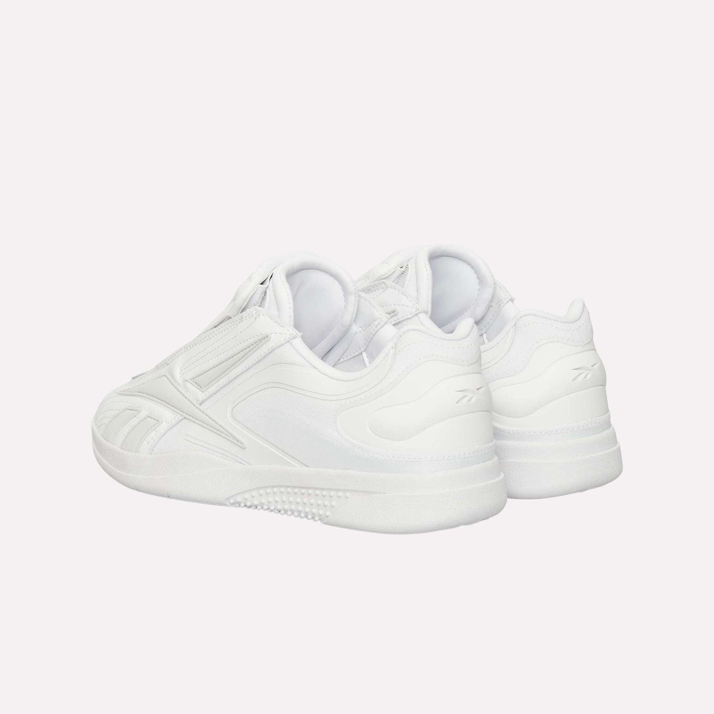 A pair of Reebok Hammer Pro Ltd sneakers with a suede upper, layered panels, and durable rubber soles, displayed from the rear on a plain white background.