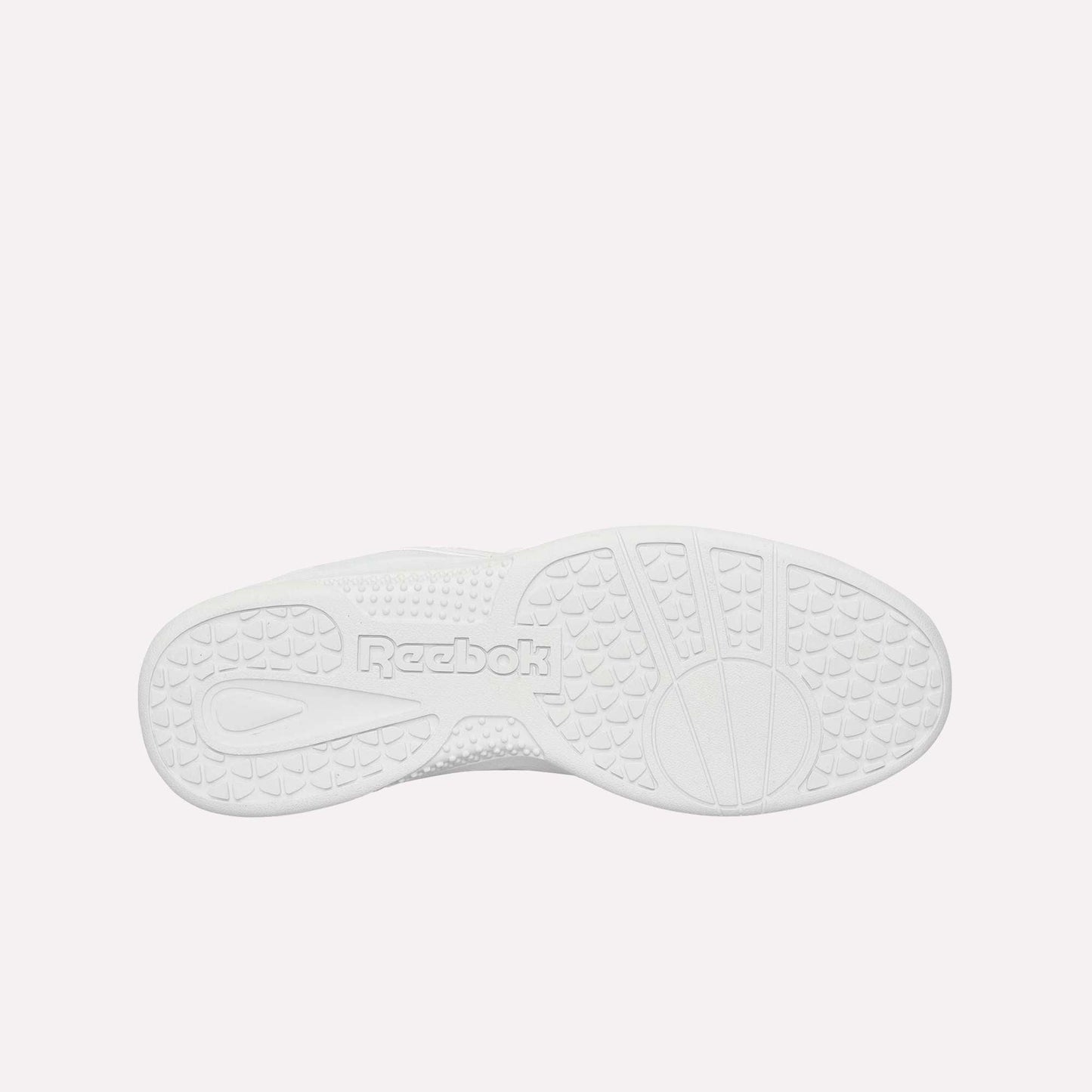 The image shows the white rubber sole of the Reebok Hammer Pro Ltd, viewed from below. It features textured grip patterns and an embossed Reebok logo in the center for durability and traction.