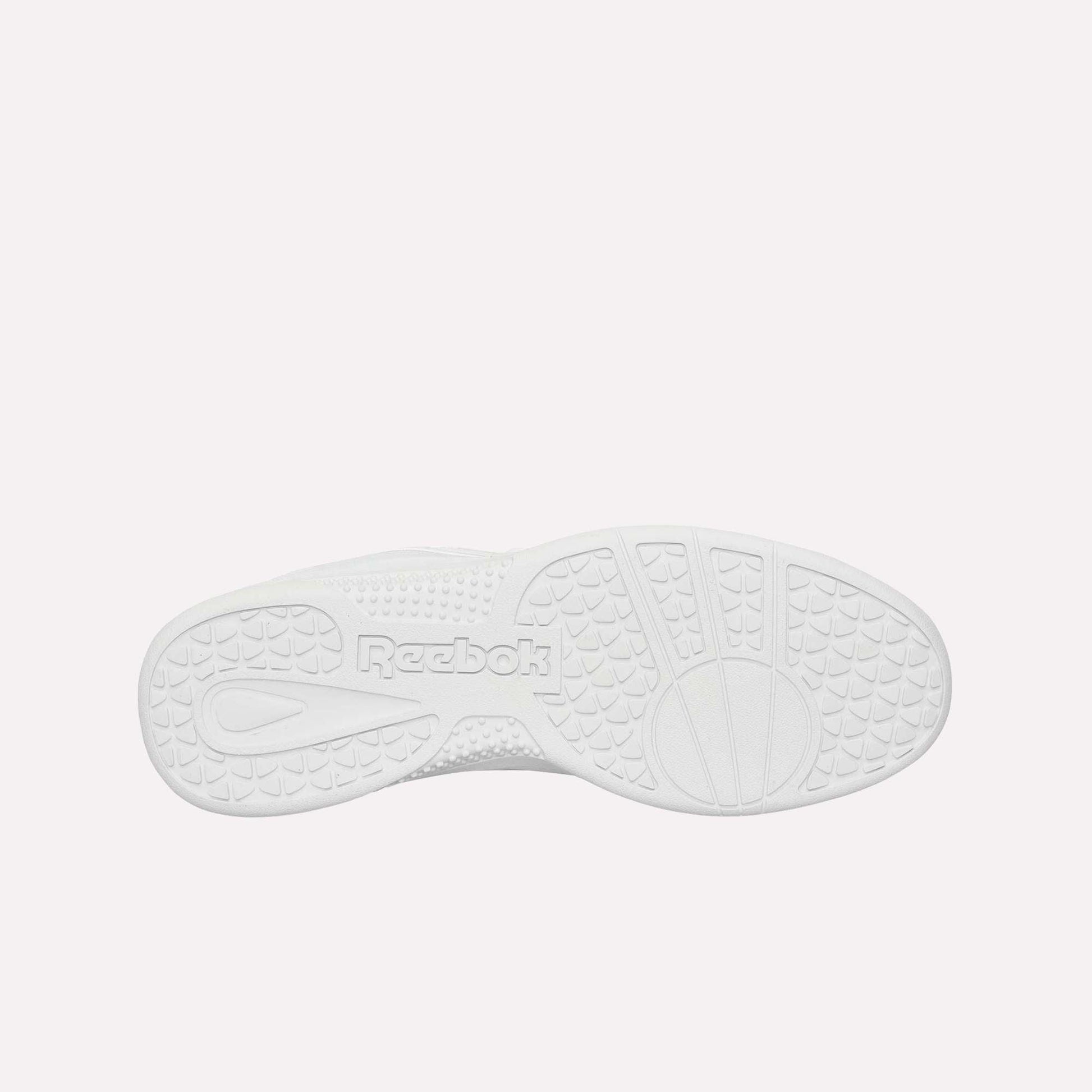 The image shows the white rubber sole of the Reebok Hammer Pro Ltd, viewed from below. It features textured grip patterns and an embossed Reebok logo in the center for durability and traction.