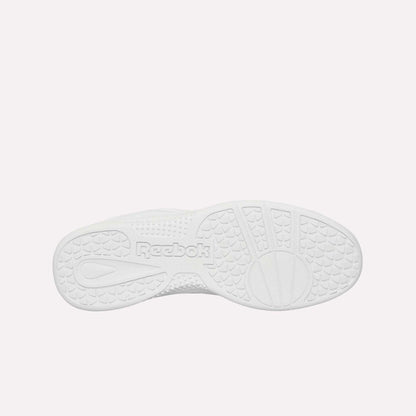 The image shows the white rubber sole of the Reebok Hammer Pro Ltd, viewed from below. It features textured grip patterns and an embossed Reebok logo in the center for durability and traction.