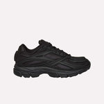 A black Reebok Premier Road Modern running shoe with a chunky sole and layered, textured side details is shown from the left against a white background.