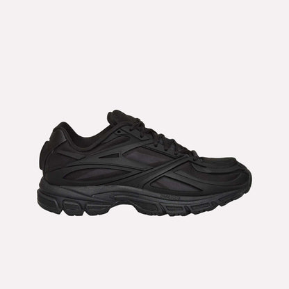 A black Reebok Premier Road Modern running shoe with a chunky sole and layered, textured side details is shown from the left against a white background.