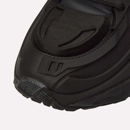 Close-up of the front of the Reebok Premier Road Modern, highlighting textured details, layered materials, and stitching on the toe and sides of this sleek black running shoe.