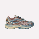 The Reebok Premier Road Ultra LTD Shoes, shown from the side against a plain light background, feature blue, beige, and brown mesh and synthetic overlays. Inspired by archival running silhouettes, these athletic sneakers are equipped with a dual-density midsole for enhanced comfort and support.