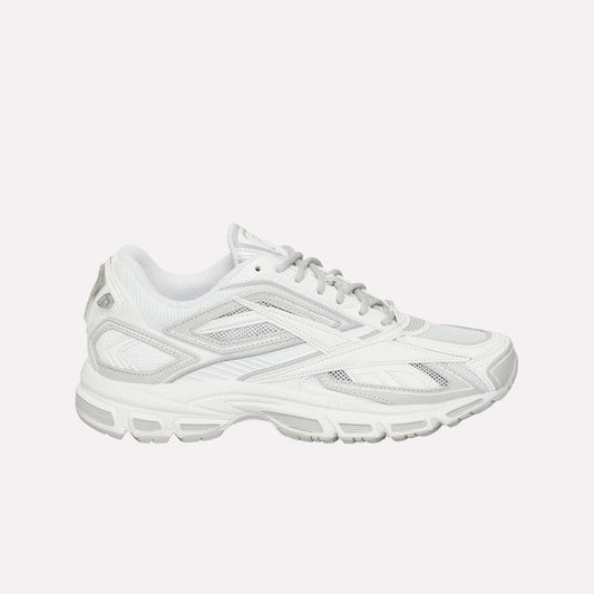 The Reebok Premier Road Ultra LTD Shoes are displayed in a side view against a plain white background. This white athletic running sneaker features gray accents, mesh panels, and a dual-density midsole. Inspired by the original Reebok Premier Road Ultra, the design includes a textured rubber sole for enhanced traction and comfort.